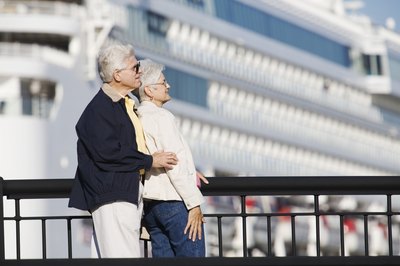 A woman leans into a man on a pier.