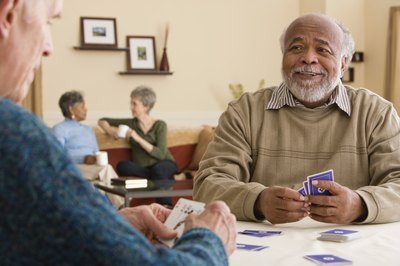 Two senior men playing a card game.