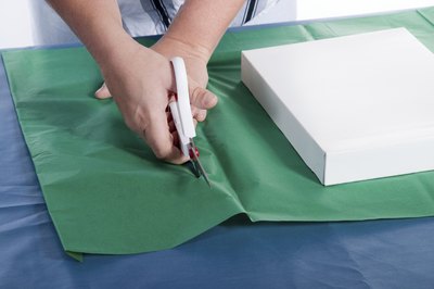 A small gift box with green wrapping paper.