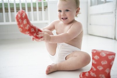 Toddler putting on boots