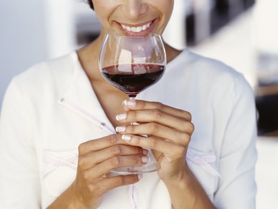 Woman holding glass of wine