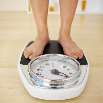 Close-up of a woman standing on a scale.