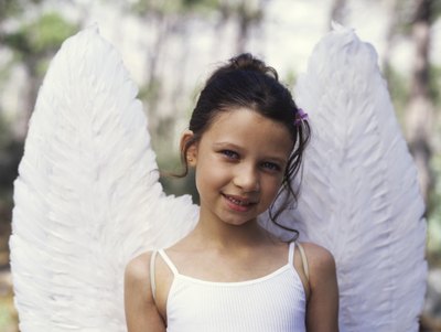 A girl wears a dress with angel wings.