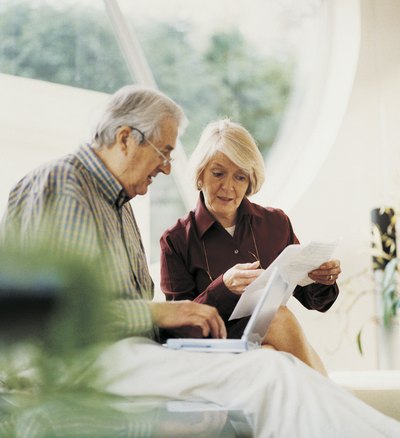 Senior couple looking at bills