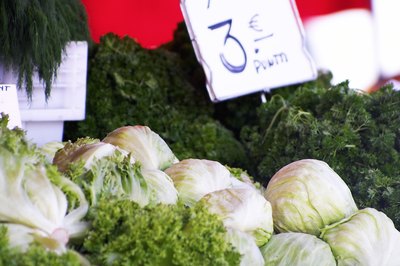 Heads of lettuce for sale at a market.