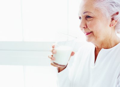 Elderly woman drinking milk