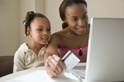 Little girl online shopping with Mom