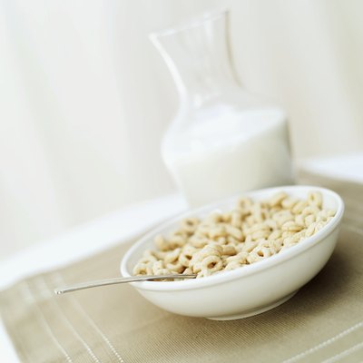 Bowl of dry cereal on tabletop.