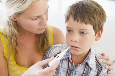 Mother taking son's temperature