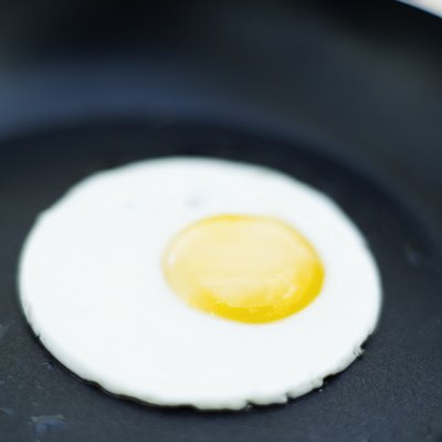 An egg fries in a pan.