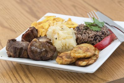 A typical Cuban dish containing fried pork, yucca and rice.