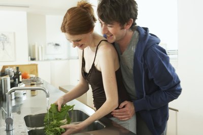 Couple preparing vegetables.