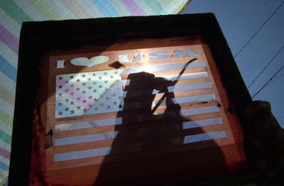 Man prepares a silkscreen to make t-shirts