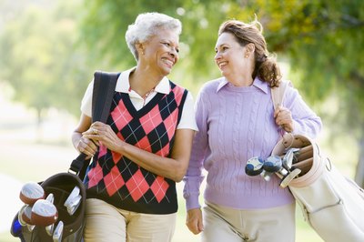 Friends walking on golf course