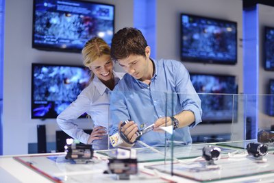 Couple in consumer electrics store buying a camera