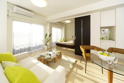 A white living room and dining area with lime green accents.
