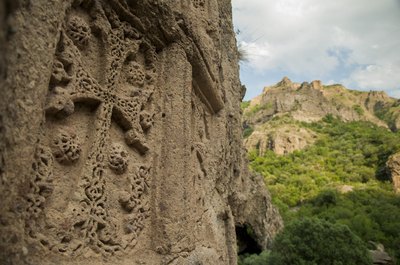 Close-up of medieval art carved into a large rock.