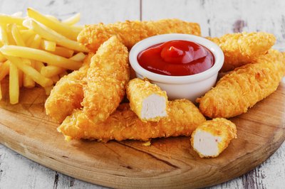 Chicken tenders with french fries and ketchup