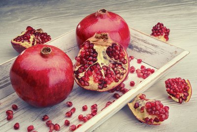 Halved and whole pomegranates.