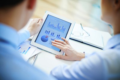 business co-workers looking at charts on iPad