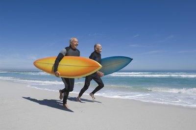 Senior men running on beach