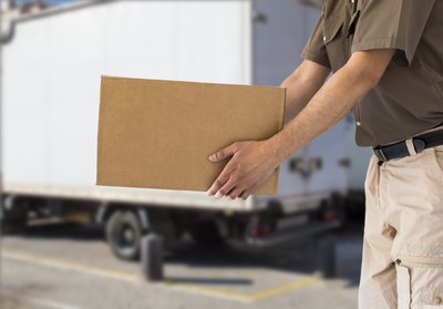 An employee delivers a truckload of cardboard boxes.