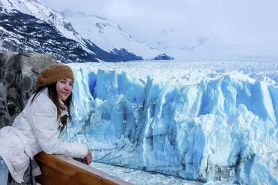 Woman aboard cruise ship near Antarctic glacier