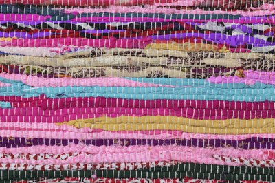 Close-up of a colorful braided rug.