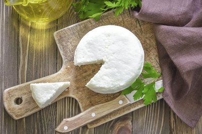 Soft cheese on cutting board