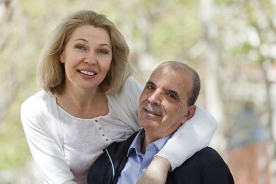 Couple holding each other and smiling for camera.