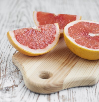 Sliced grapefruit on cutting board.