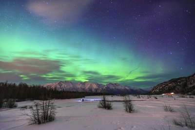 The aurora borealis is seen looking over Knik River in Alaska.