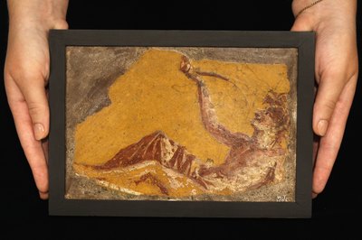 Colorful wall painting fragment found in the ruins of Pompeii