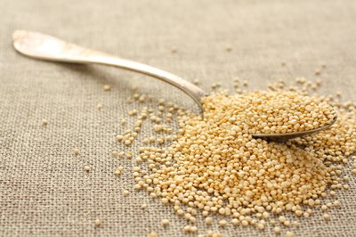 A spoon in a pile of quinoa grain.