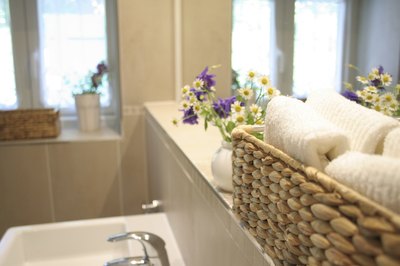 A basket of folded towels in a clutter-free bathroom.