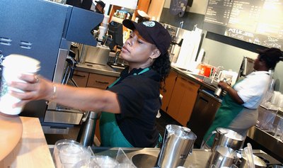 Starbucks staff readies a drink for a customer