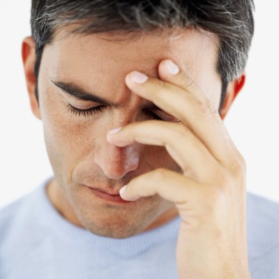 Man holding forehead
