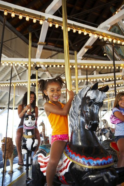 Young girl on ride at amusement park