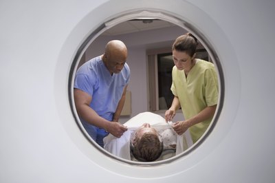 MRI technicians preparing patient for scan