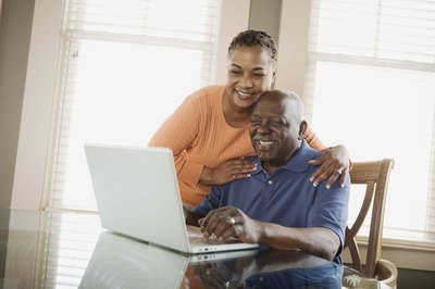 parents assembling a photo slideshow of graduate
