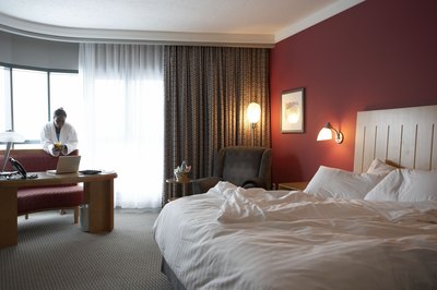 Woman working at desk in hotel room