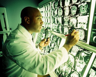 Doctor looking over MRI monitoring screens