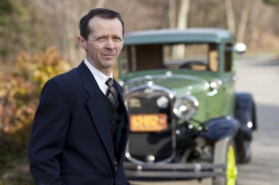 Man standing in front of a Model T Auto