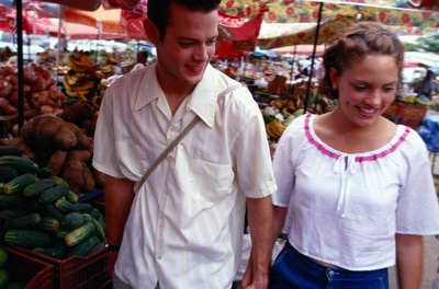 A couple shops at an organic produce stand.