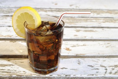 Glass of soda with lemon and straw