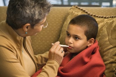 grandmother checking her grandson's temperature