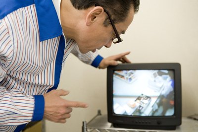 Business manager is looking at a security recording.