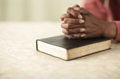 woman with hands on bible