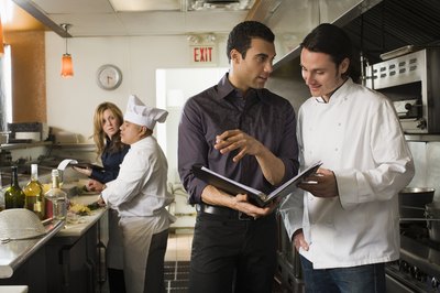 Kitchen staff working together in restaurant