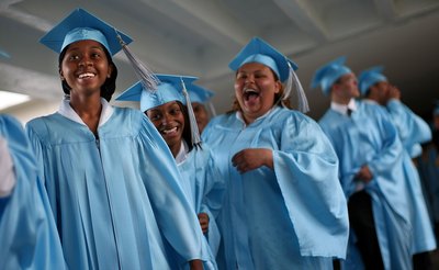 High school graduates laughing